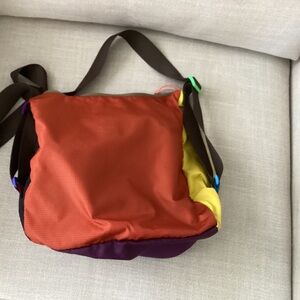Cotopaxi cross body bag brown, blue, purple , yellow. Beautiful new colors.